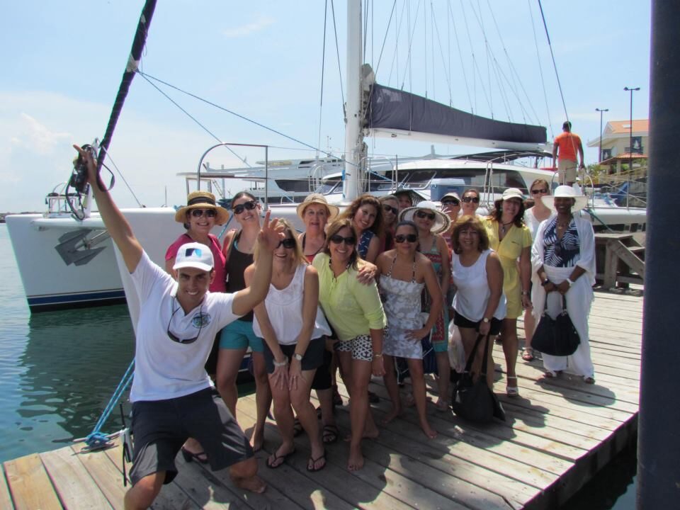 Grupo de clientes posando en el muelle antes de zarpar en tour de Fiesta en Yate